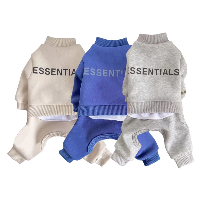 Three dog sweaters in beige, blue, and gray with 'ESSENTIALS' branding on a white background.