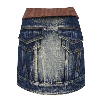 Blue denim dog jacket with brown trim on a white background