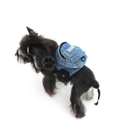Dog wearing a denim-style bag with paw print design on a white background