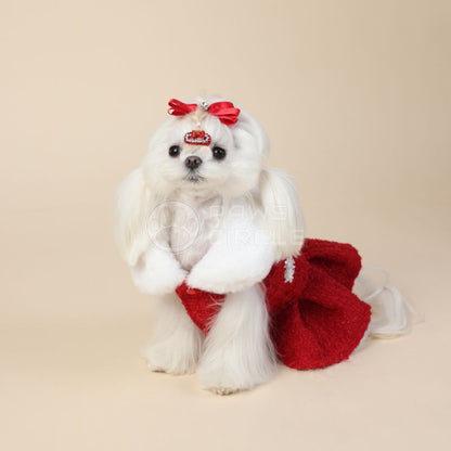 Stuffed toy dog with a red bow and skirt on a beige background