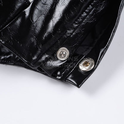 Close-up of a black leather jacket with silver buttons on a white background