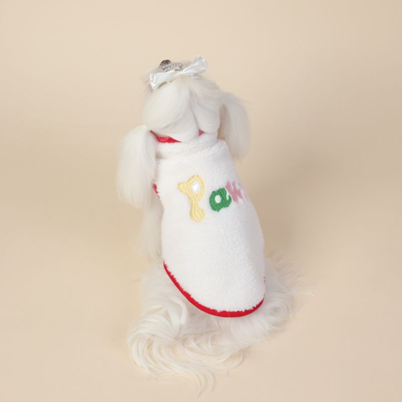 White dog dress with colorful letters on a beige background