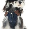 Dog wearing a denim outfit with brown accents on a white background