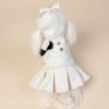 White dog dress with buttons and a bow on a beige background