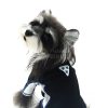 Dog wearing a black outfit with white accents on a white background