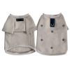 Two beige chrome hearts dog sweaters with decorative buttons on a white background