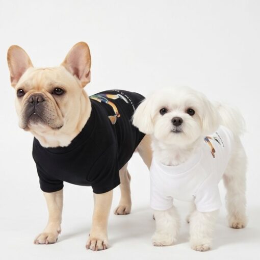 Two small dogs wearing Polo Pup Club Tennis Bear tees