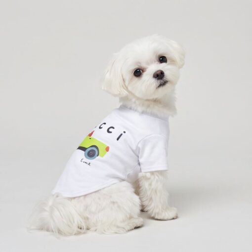 Small dog wearing the white Pupchi Dog Driver t-shirt