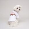 Small dog wearing the white Pupchi Ribbon dog tee